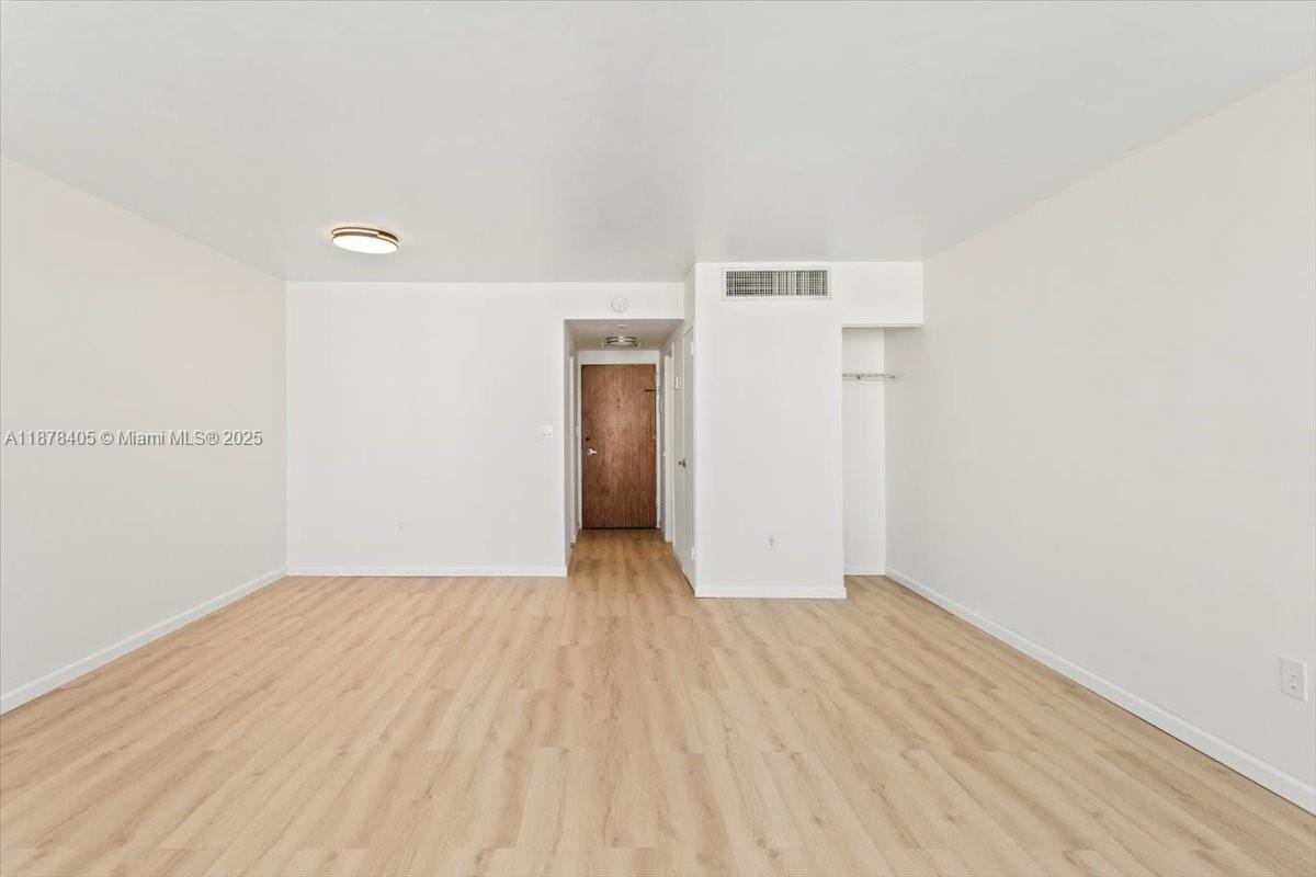 2899 Collins Avenue, Unit 1104 Miami Beach, FL 33140 - Photo 16 of 21 a view of a room with wooden floor