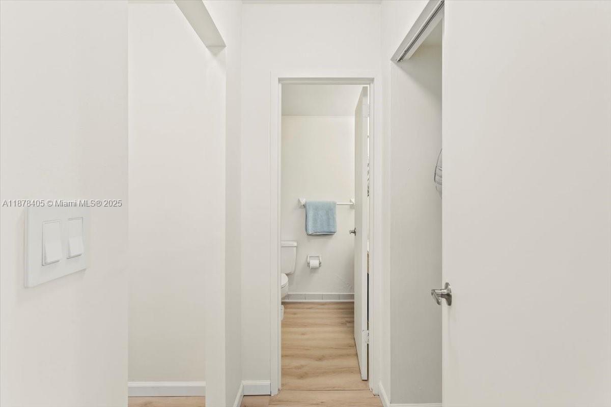 2899 Collins Avenue, Unit 1104 Miami Beach, FL 33140 - Photo 10 of 21 a view of a bathroom from a hallway