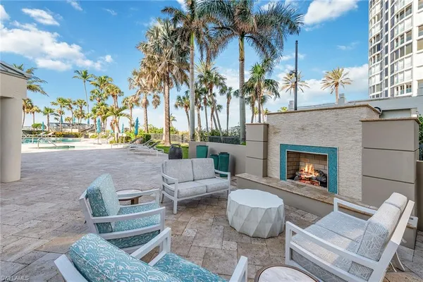 a view of a patio with couches and a fire pit and a fire pit