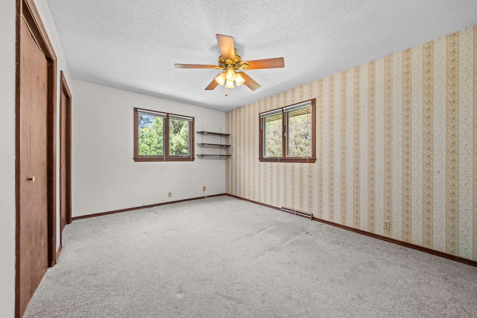5748 South Skare Road Rochelle, IL 61068 - Photo 18 of 45 an empty room with windows and chandelier fan