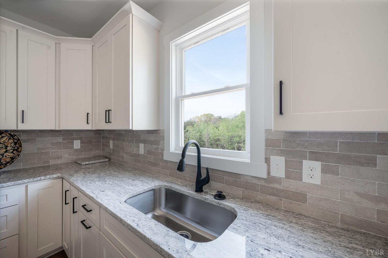 4424 Goode Road Goode, VA 24556 - Photo 23 of 71 a kitchen with granite countertop a sink and a window