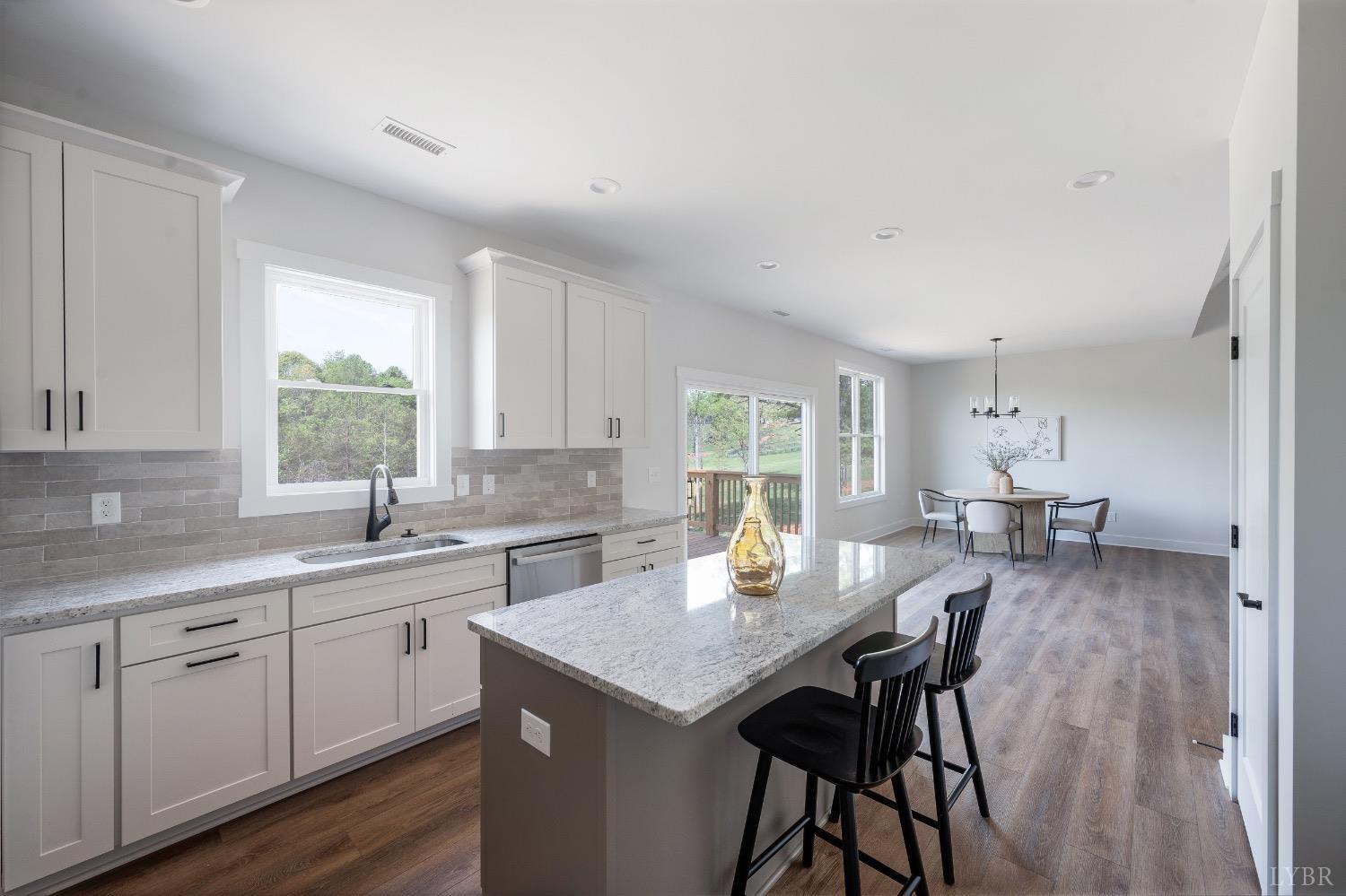 4424 Goode Road Goode, VA 24556 - Photo 26 of 71 a kitchen with a dining table chairs and sink