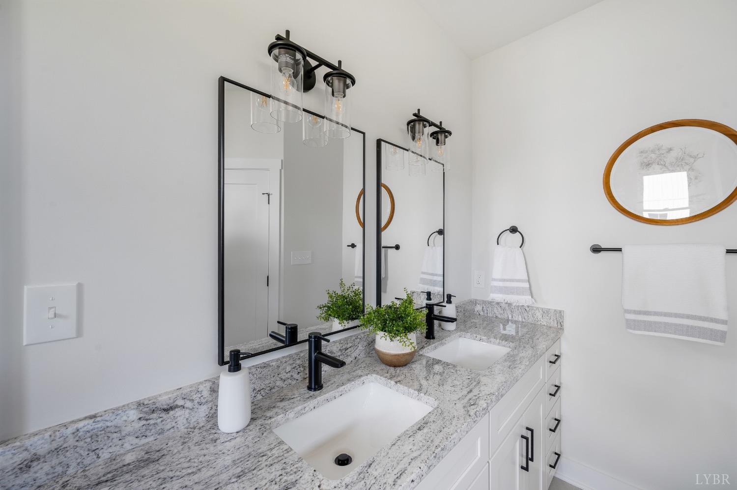 4424 Goode Road Goode, VA 24556 - Photo 35 of 71 a bathroom with a granite countertop sink and a mirror