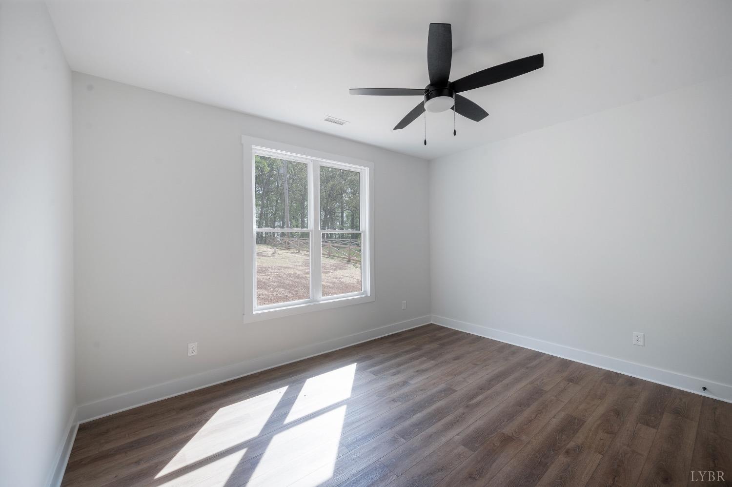 4424 Goode Road Goode, VA 24556 - Photo 45 of 71 an empty room with wooden floor fan and windows