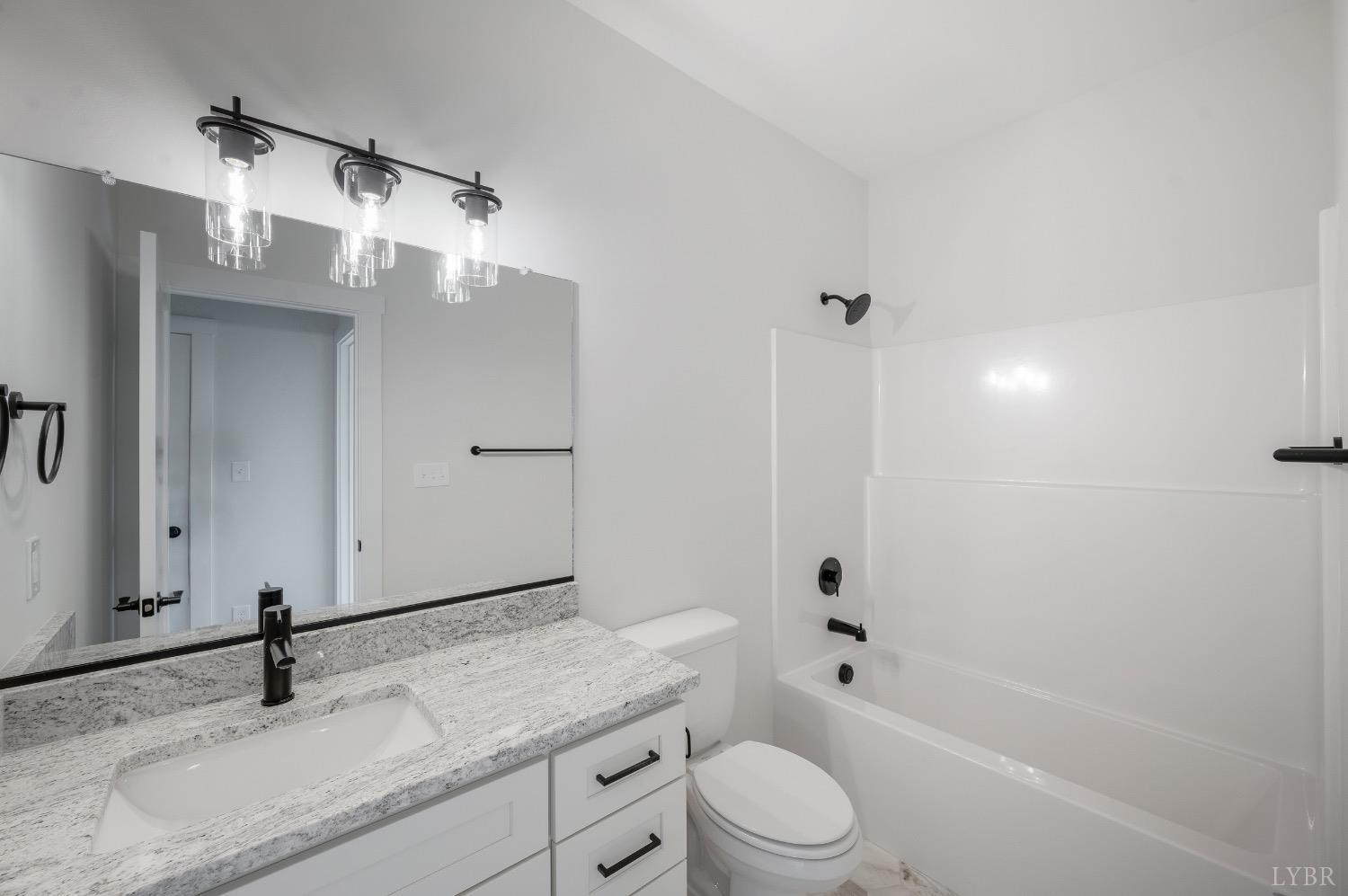 4424 Goode Road Goode, VA 24556 - Photo 47 of 71 a bathroom with a granite countertop sink toilet and shower