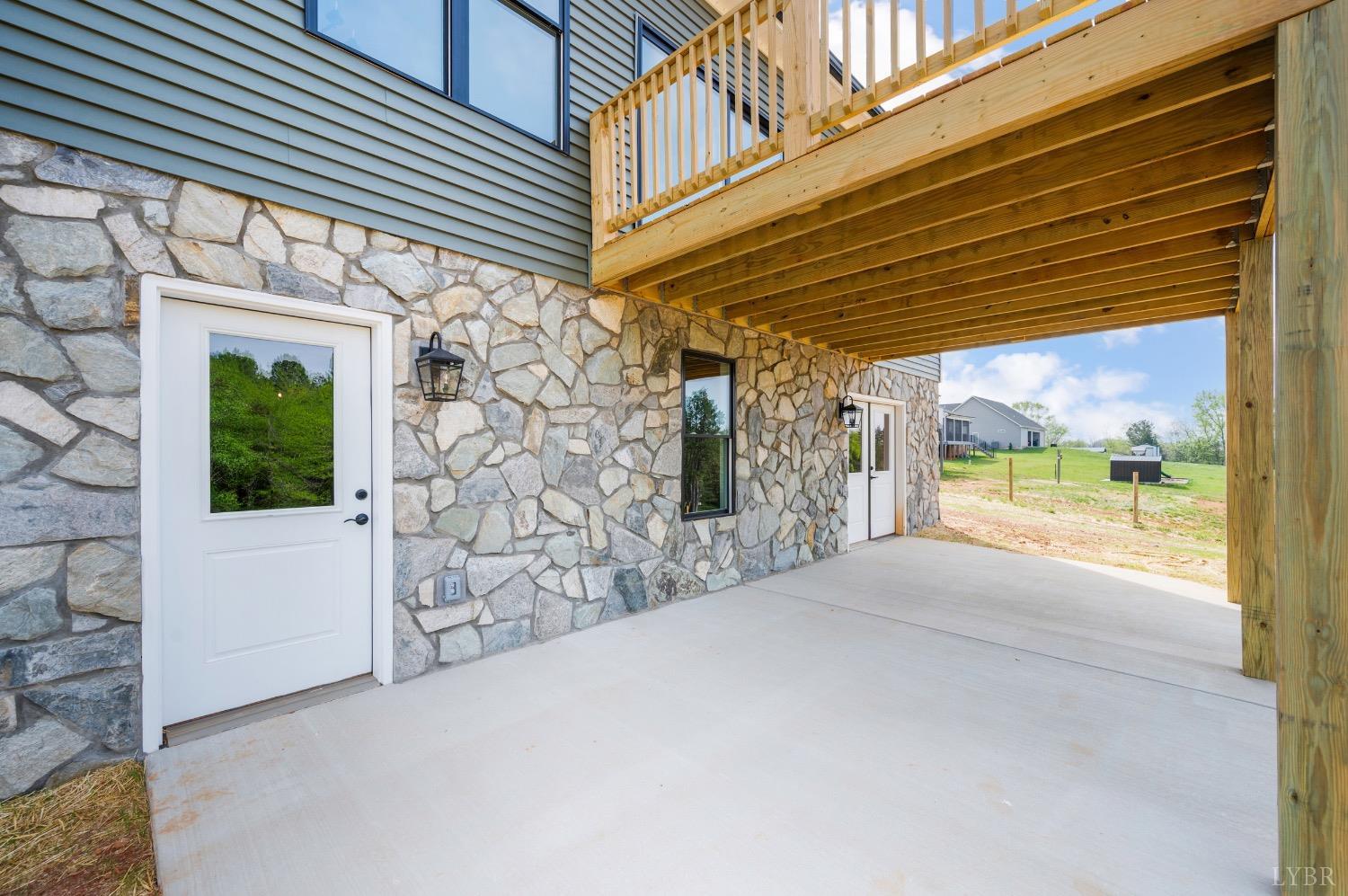 4424 Goode Road Goode, VA 24556 - Photo 56 of 71 a view of a patio with table and chairs and floor to ceiling window