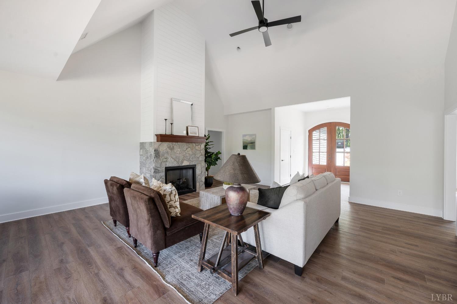 4424 Goode Road Goode, VA 24556 - Photo 10 of 71 a living room with furniture a fireplace and a wooden floor
