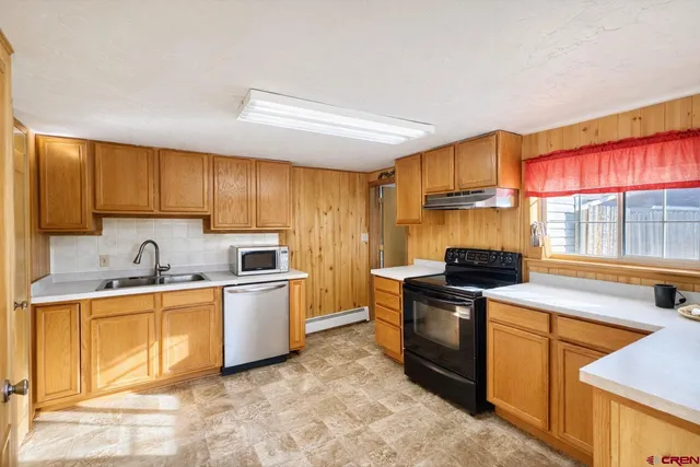 a kitchen with stainless steel appliances granite countertop a stove and a refrigerator