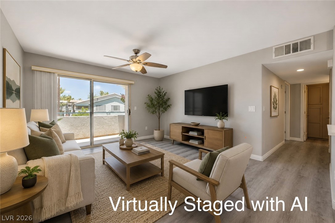 3425 East Russell Road, Unit 223 Las Vegas, NV 89120 - Photo 13 of 47 Sliding glass doors open onto a private balcony, extending the living space outdoors.