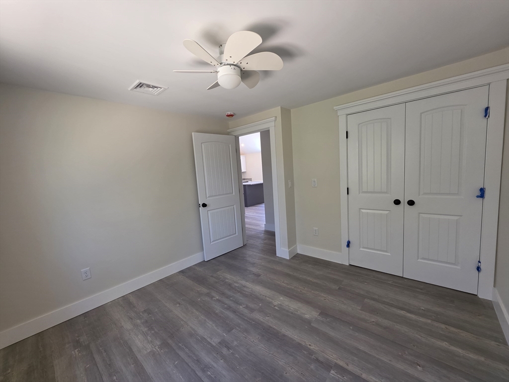 87 Acapesket Road, Unit 2A Falmouth, MA 02536 - Photo 9 of 17 a view of an empty room with wooden floor