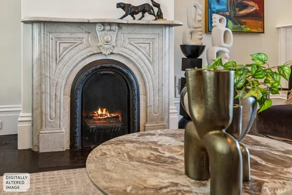 a living room with furniture a fireplace and a chandelier