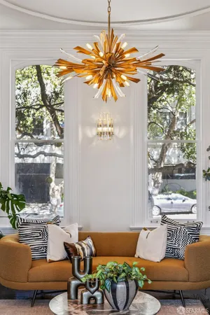 a living room with fireplace furniture and a chandelier