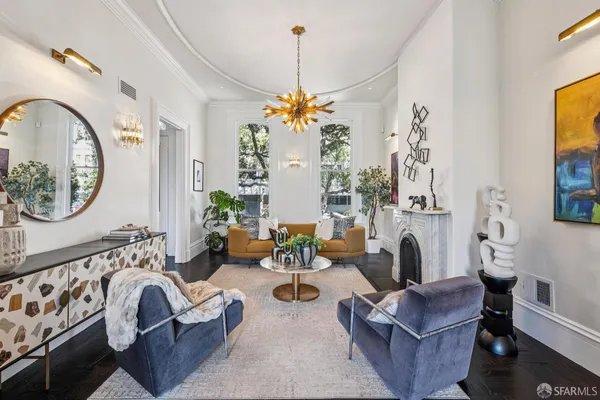 a living room with fireplace furniture and a chandelier
