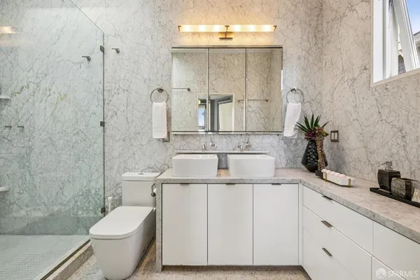 a view of balcony with table and chairs and potted plants