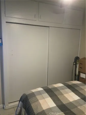 a bedroom with a bed and a cabinet