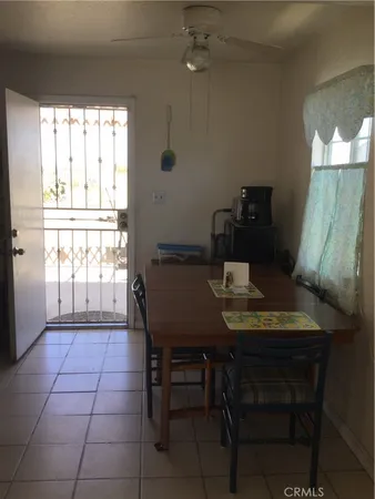 a view of a dining room with furniture and window