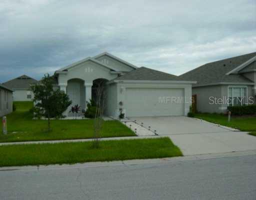 12304 Hawkeye Point Place Riverview, FL 33578 - Photo 1 of 1 a front view of a house with garage and green space