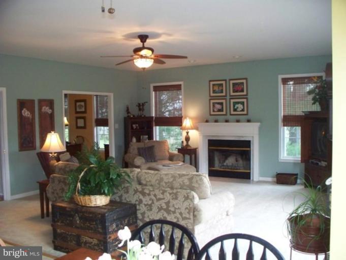 3185 Jones Road Dunkirk, MD 20754 - Photo 2 of 28 a living room with furniture a chandelier and a fireplace