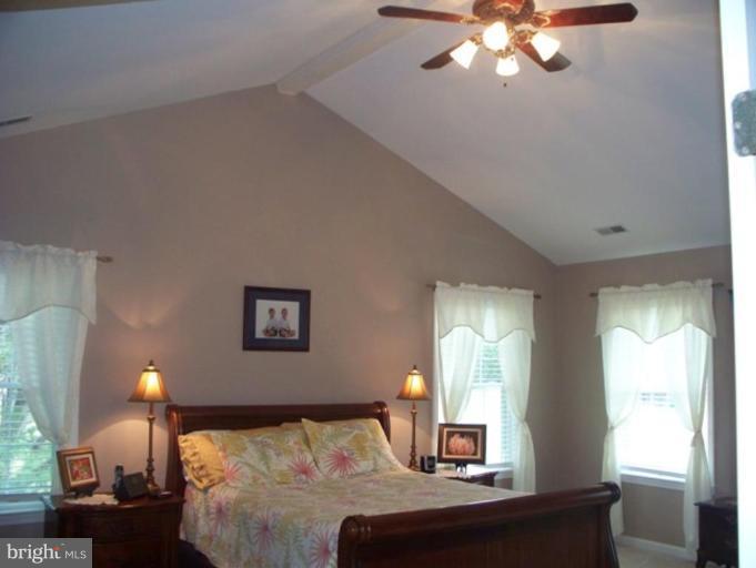 3185 Jones Road Dunkirk, MD 20754 - Photo 11 of 28 a bedroom with a bed and a chandelier