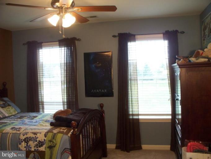 3185 Jones Road Dunkirk, MD 20754 - Photo 26 of 28 a bed sitting in a bedroom next to a window