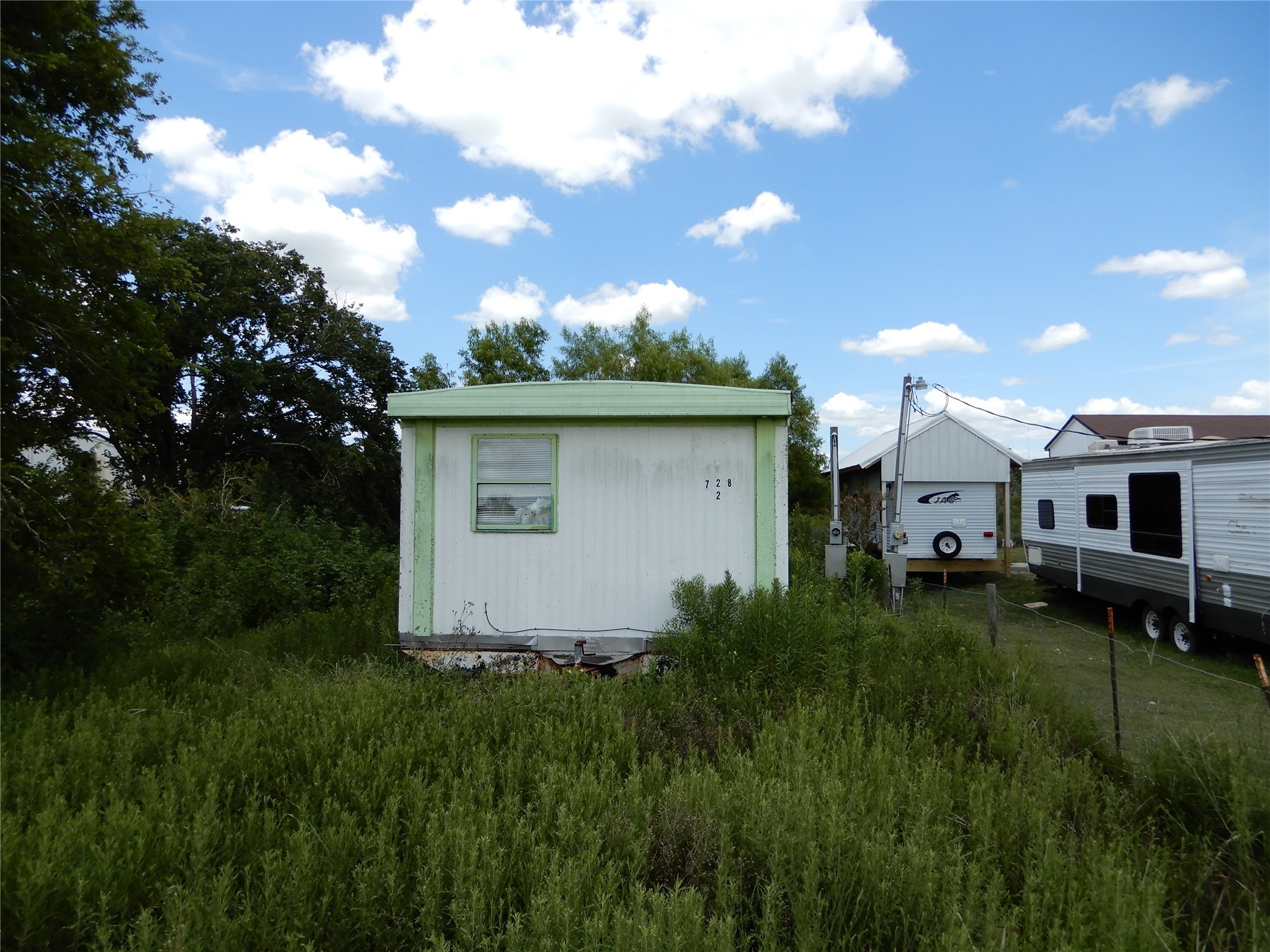 563 Fairway Drive Angleton, TX 77515 - Photo 2 of 6 a backyard of a house with table and chairs
