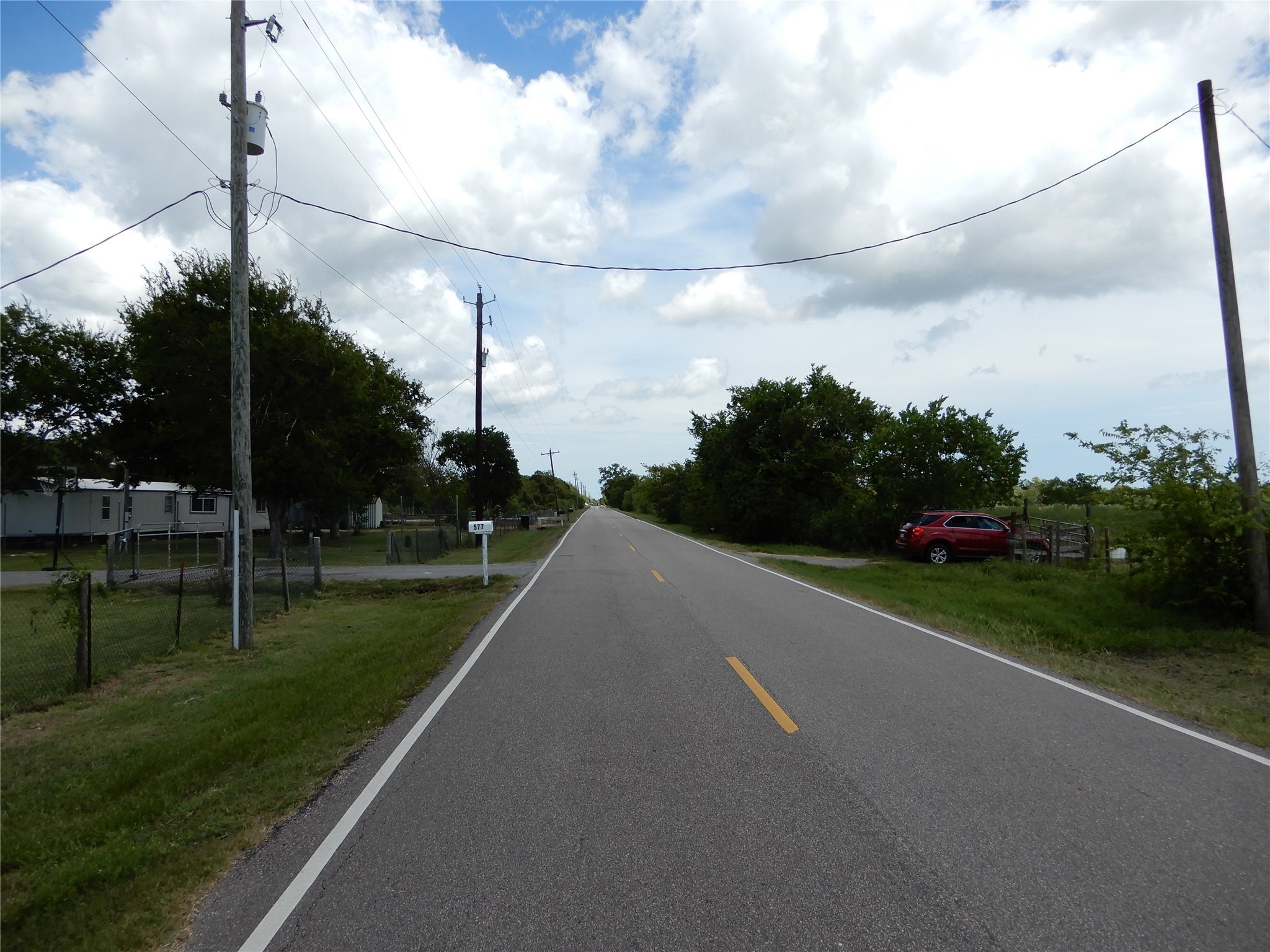 563 Fairway Drive Angleton, TX 77515 - Photo 5 of 6 a view of a street both of side forest