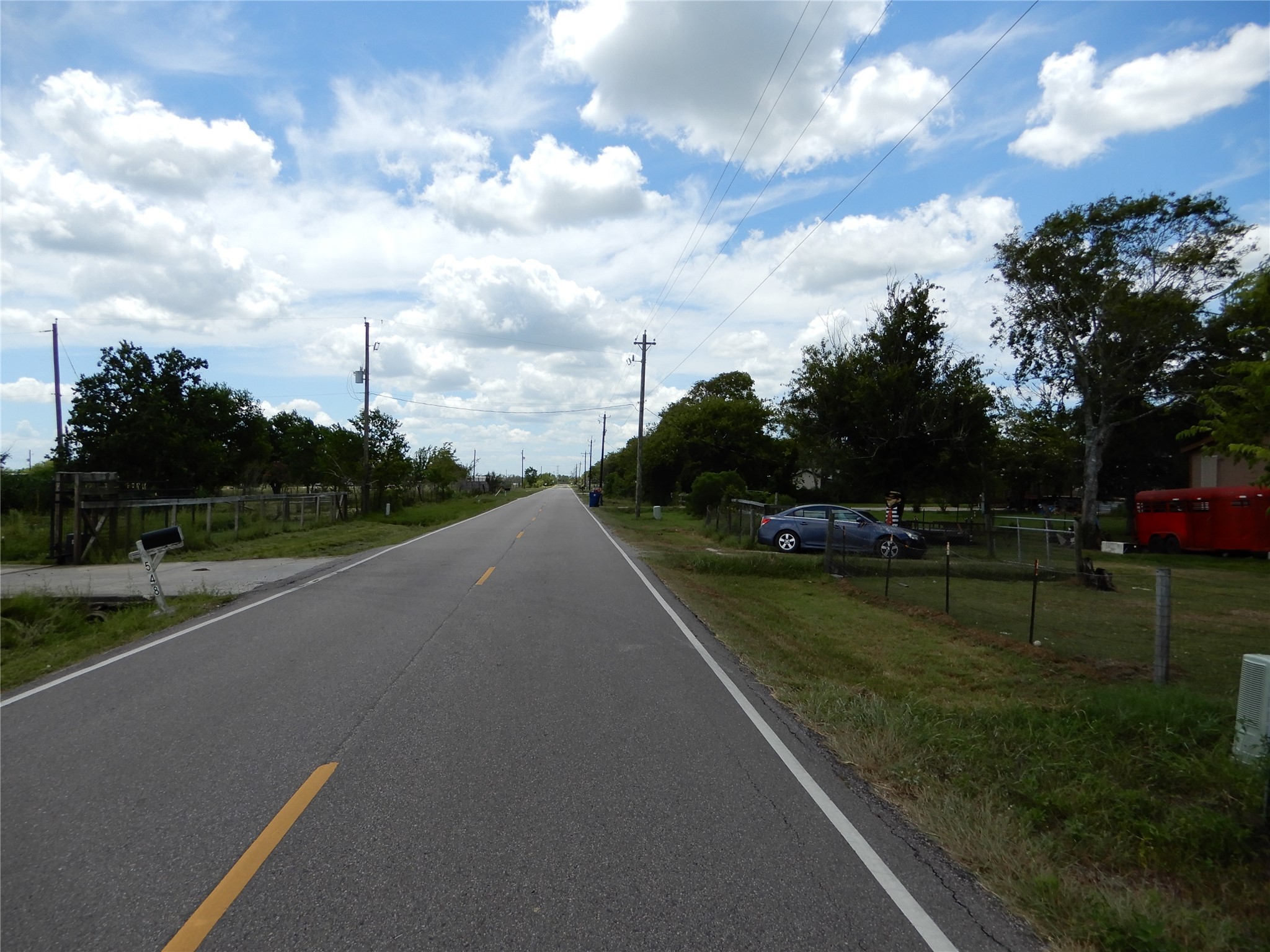 563 Fairway Drive Angleton, TX 77515 - Photo 6 of 6 a view of a street with a yard