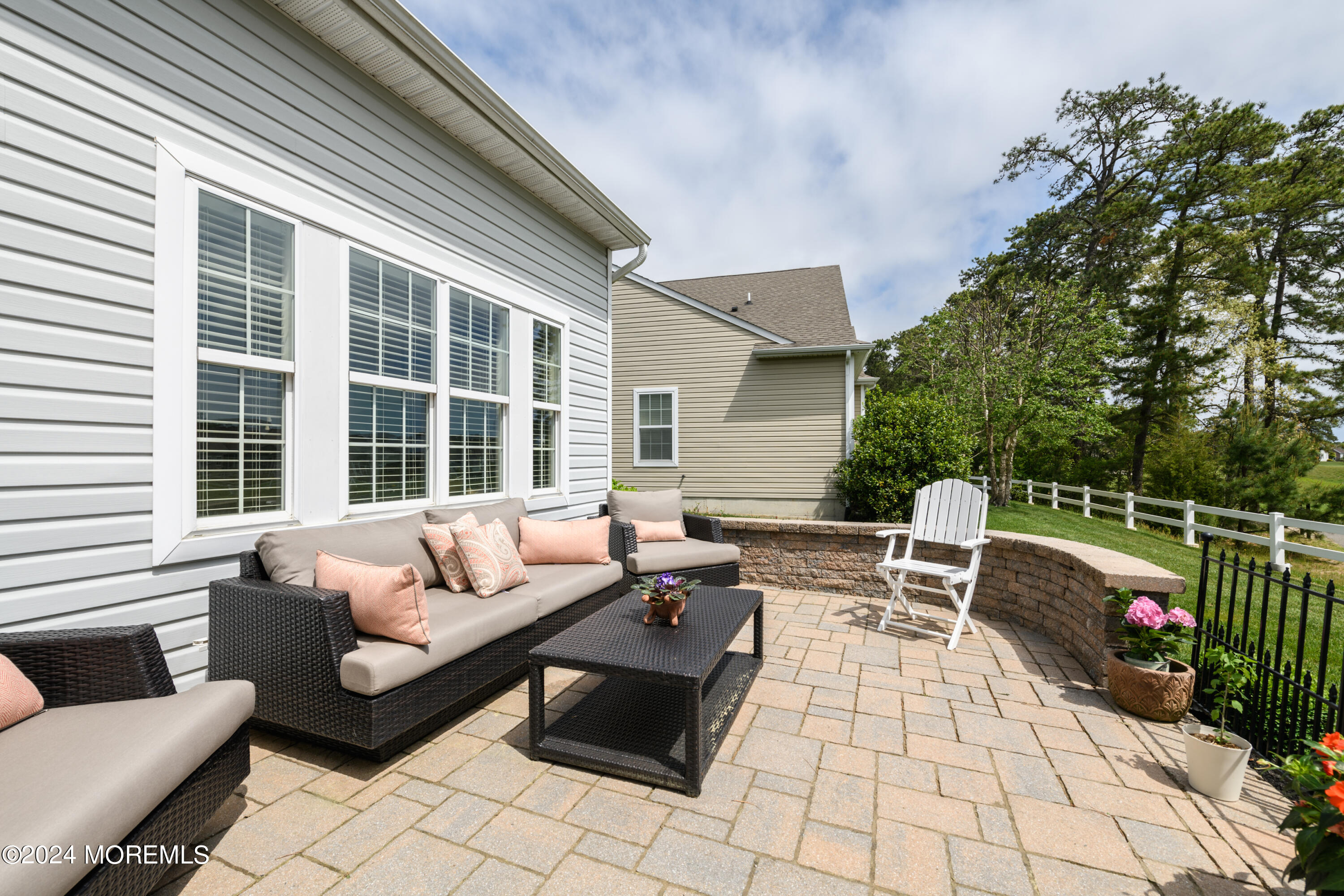 23 Sea Bright Way Waretown, NJ 08758 - Photo 11 of 59 a view of a patio with couches and a table and chairs with wooden floor and fence