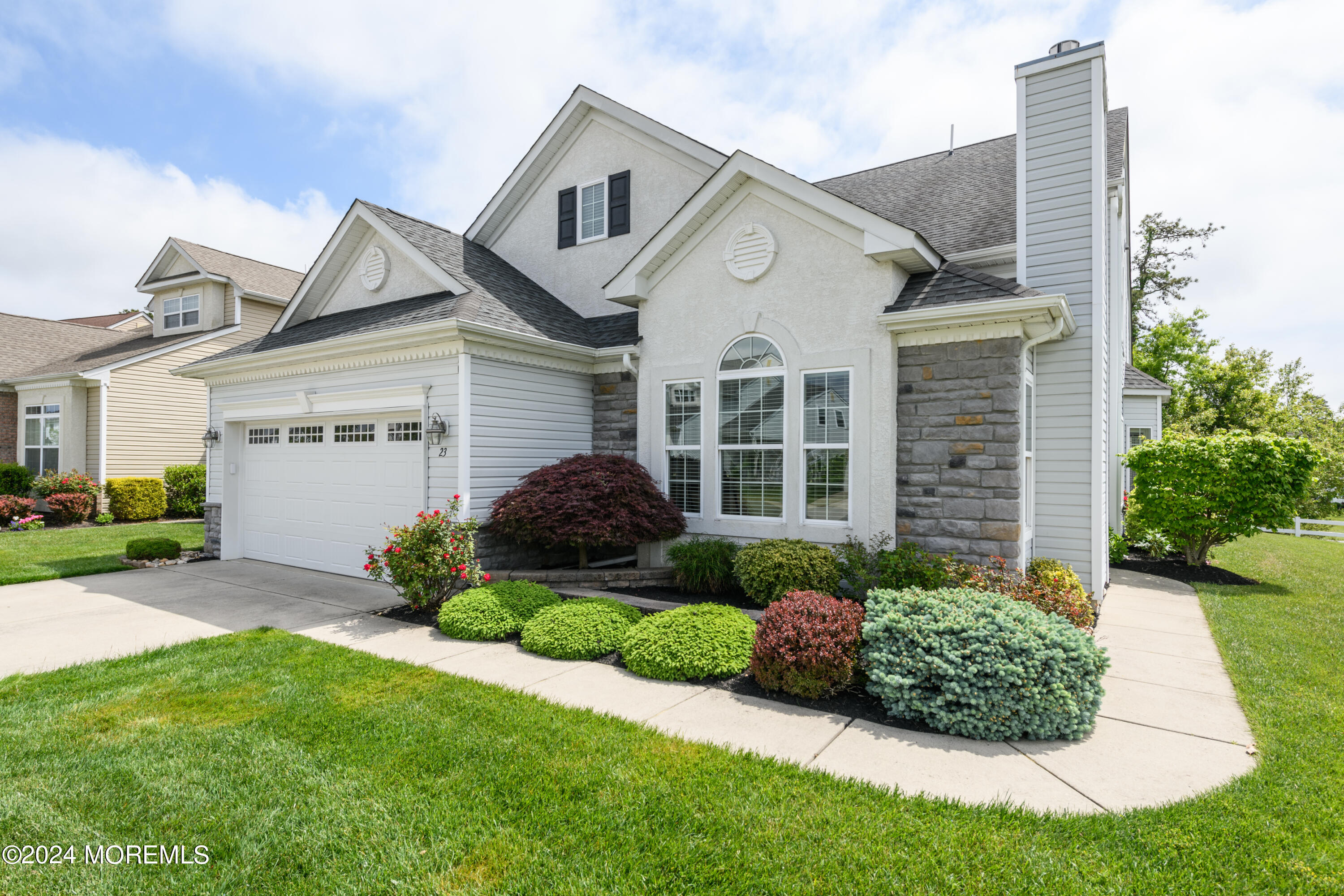 23 Sea Bright Way Waretown, NJ 08758 - Photo 14 of 59 a front view of a house with a garden and plants
