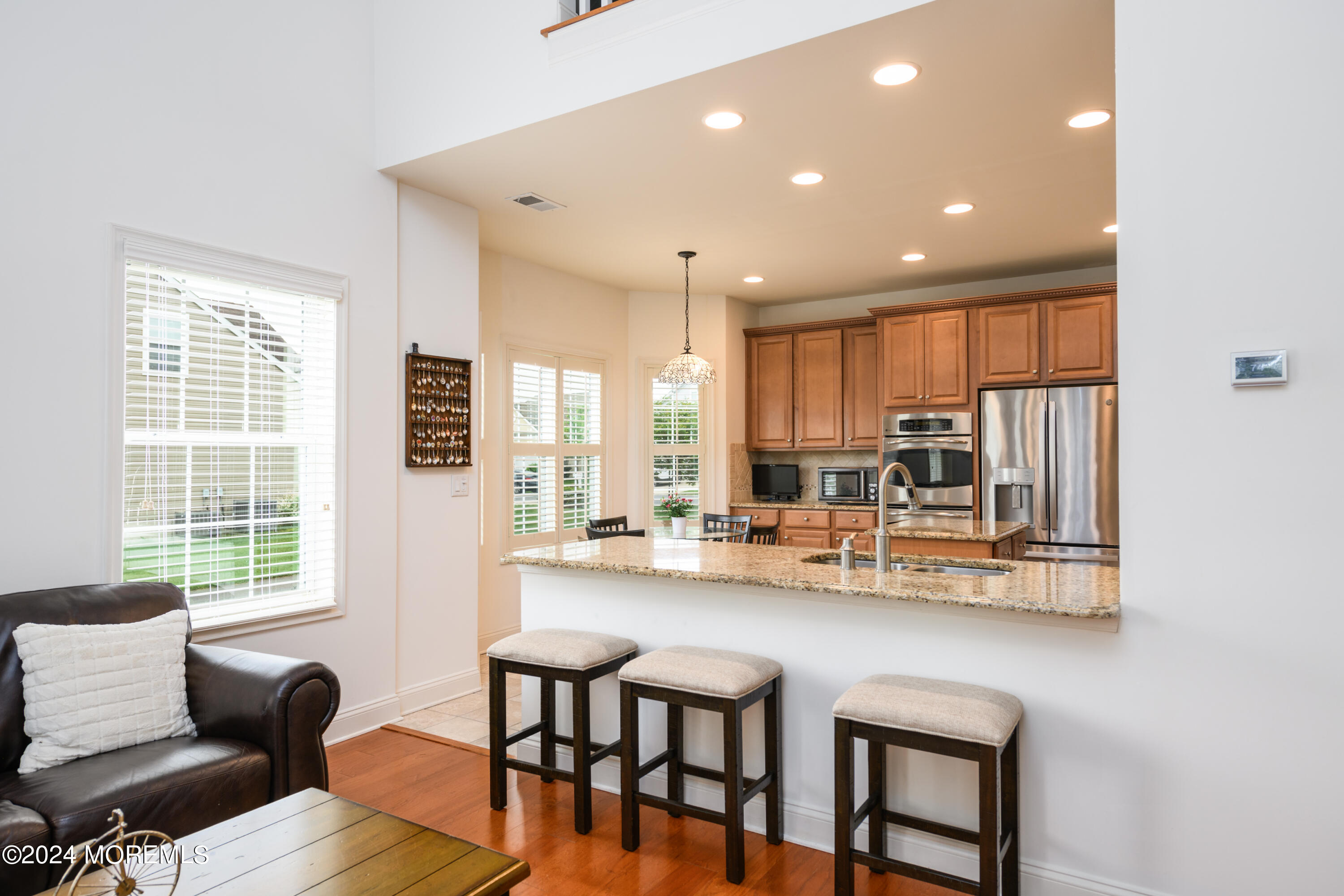 23 Sea Bright Way Waretown, NJ 08758 - Photo 24 of 59 a kitchen with stainless steel appliances kitchen island granite countertop a stove a refrigerator a sink dishwasher with a dining table and chairs