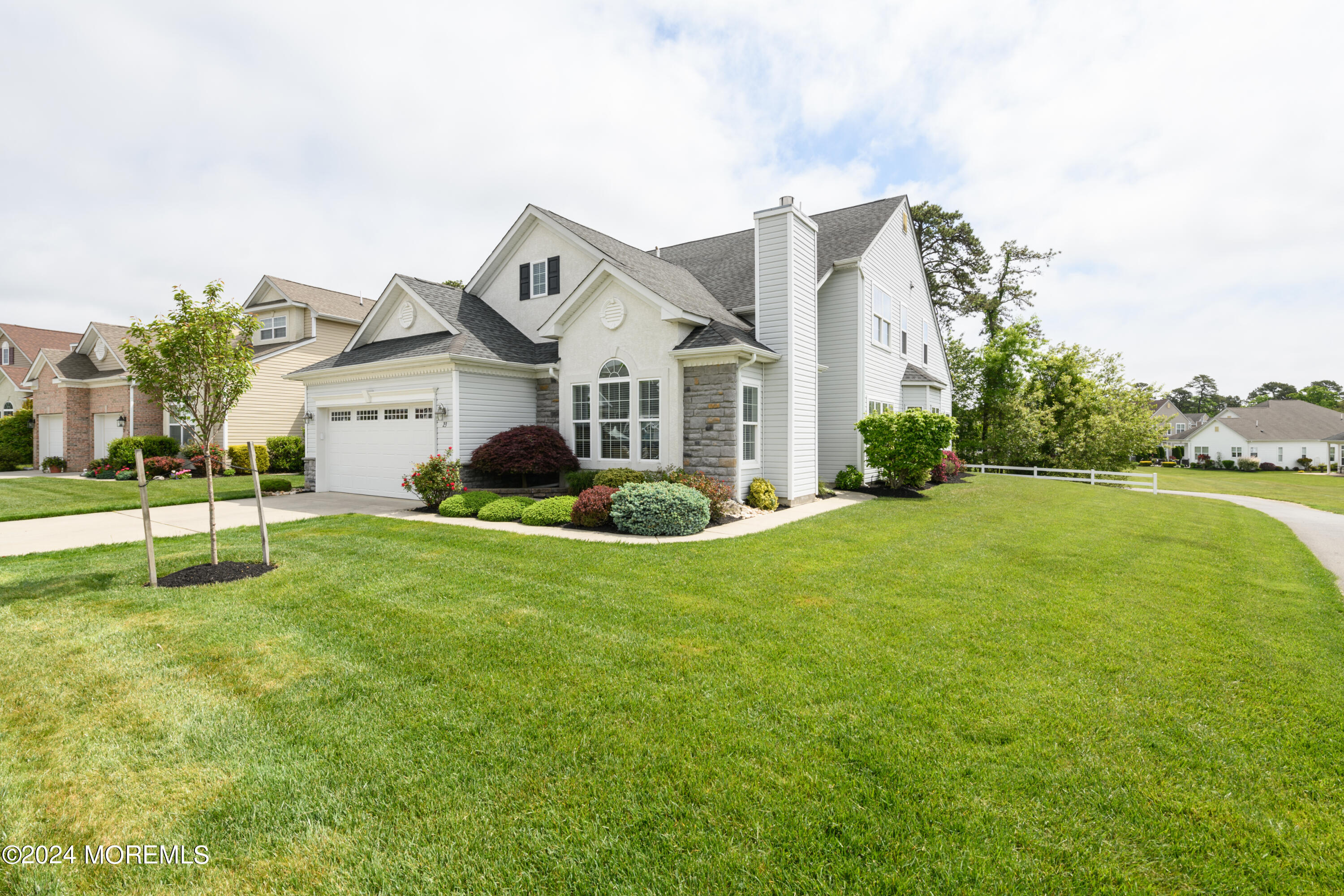 23 Sea Bright Way Waretown, NJ 08758 - Photo 4 of 59 a front view of a house with a garden and yard