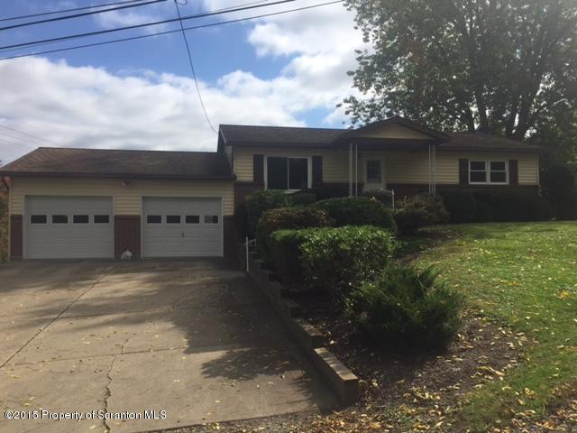 154 Tinklepaugh Road Meshoppen, PA 18630 - Photo 2 of 11 a front view of a house with a yard and garage