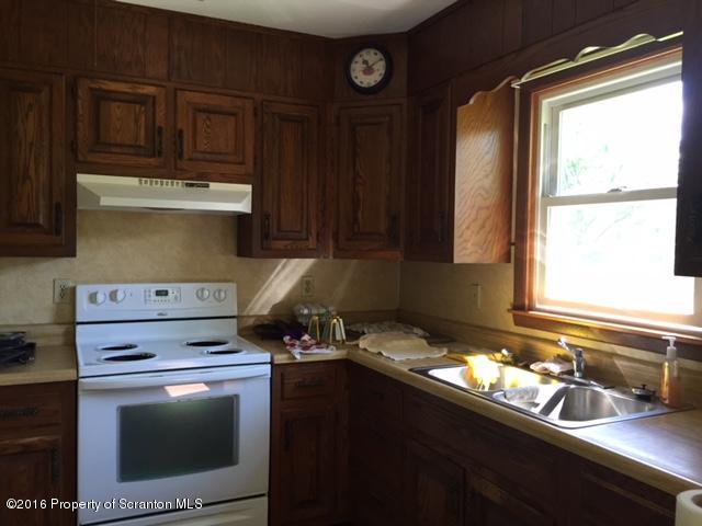 154 Tinklepaugh Road Meshoppen, PA 18630 - Photo 4 of 11 a kitchen with a stove and a microwave