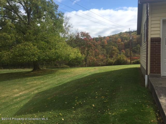 154 Tinklepaugh Road Meshoppen, PA 18630 - Photo 8 of 11 a view of a green field with wooden fence