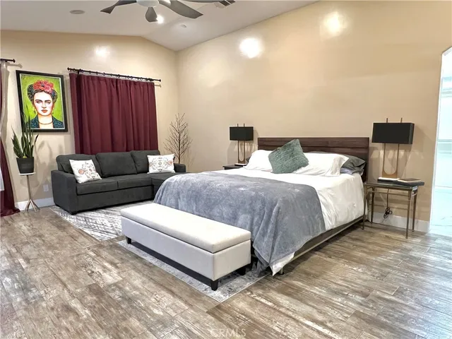 a bedroom with double bed and a couch