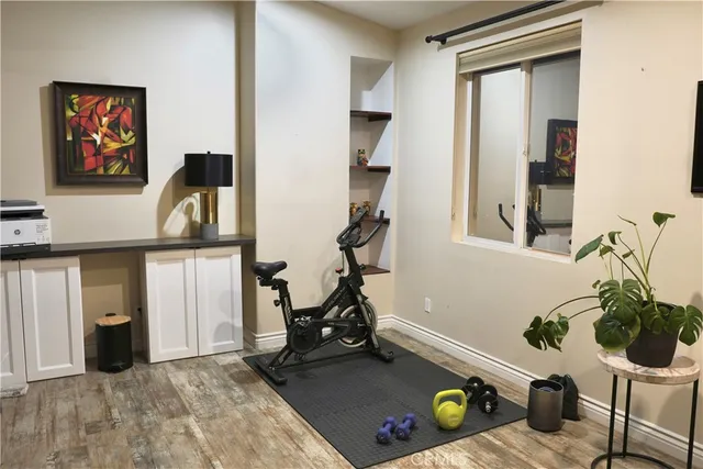 a room with gym equipment and view of living room