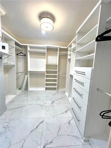 a view of walk in closet with empty racks