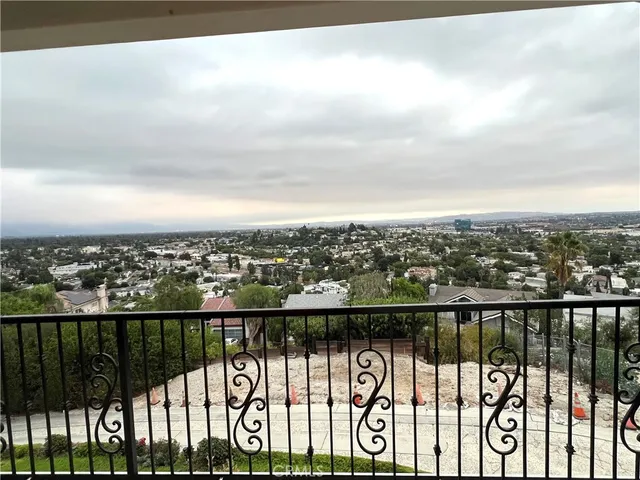 a large bed sitting in a bedroom next to a window