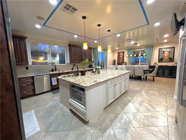 a large kitchen with a large counter top appliances and cabinets