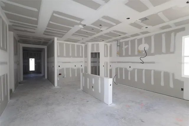a view of an empty room with white walls