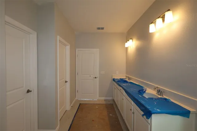 a bathroom with a sink and mirror