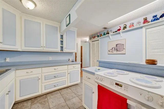 a kitchen with granite countertop cabinets stainless steel appliances and wooden floor
