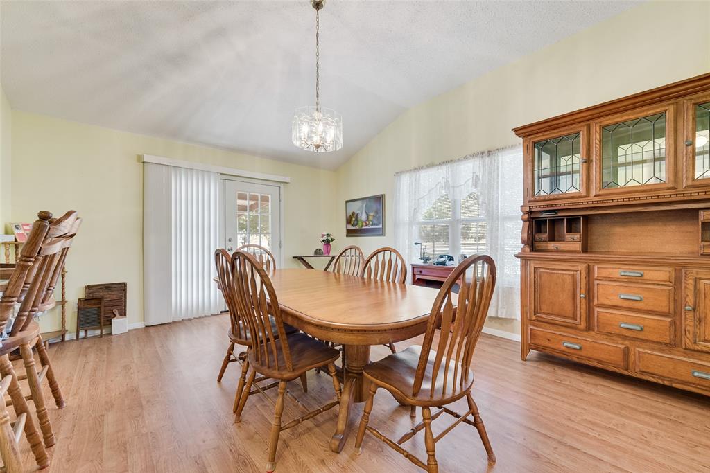 646 Liska Road Ennis, TX 75119 - Photo 12 of 23 a view of a dining room with furniture window and wooden floor