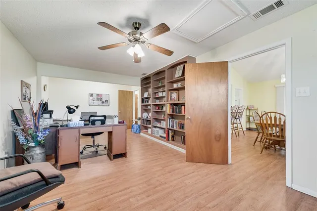a view of a livingroom with workspace and a window