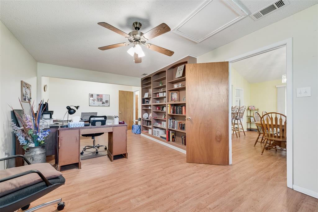 646 Liska Road Ennis, TX 75119 - Photo 13 of 23 a view of a livingroom with workspace and a window