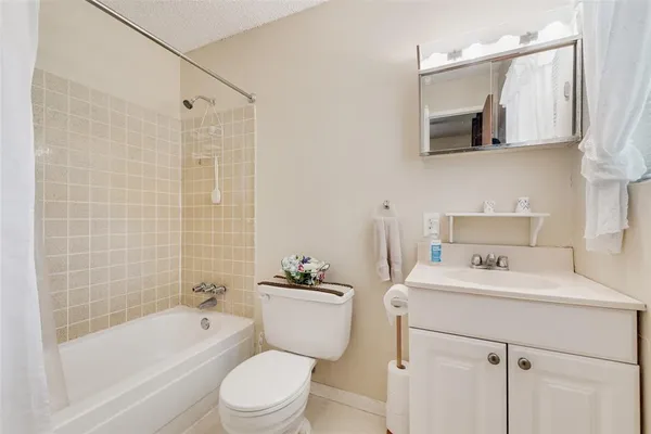 a bathroom with a sink toilet a mirror and shower