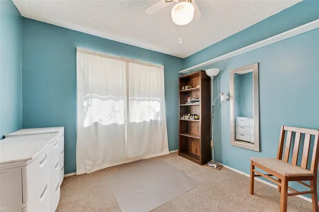 a view of an empty room and bathroom with a tub