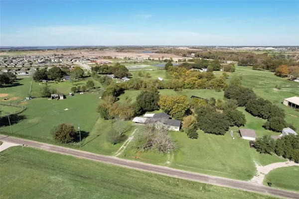 an aerial view of a golf course with houses