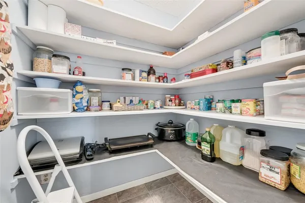 a room with storage and a shelf