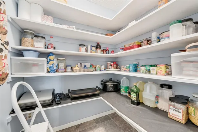 a room with storage and a shelf